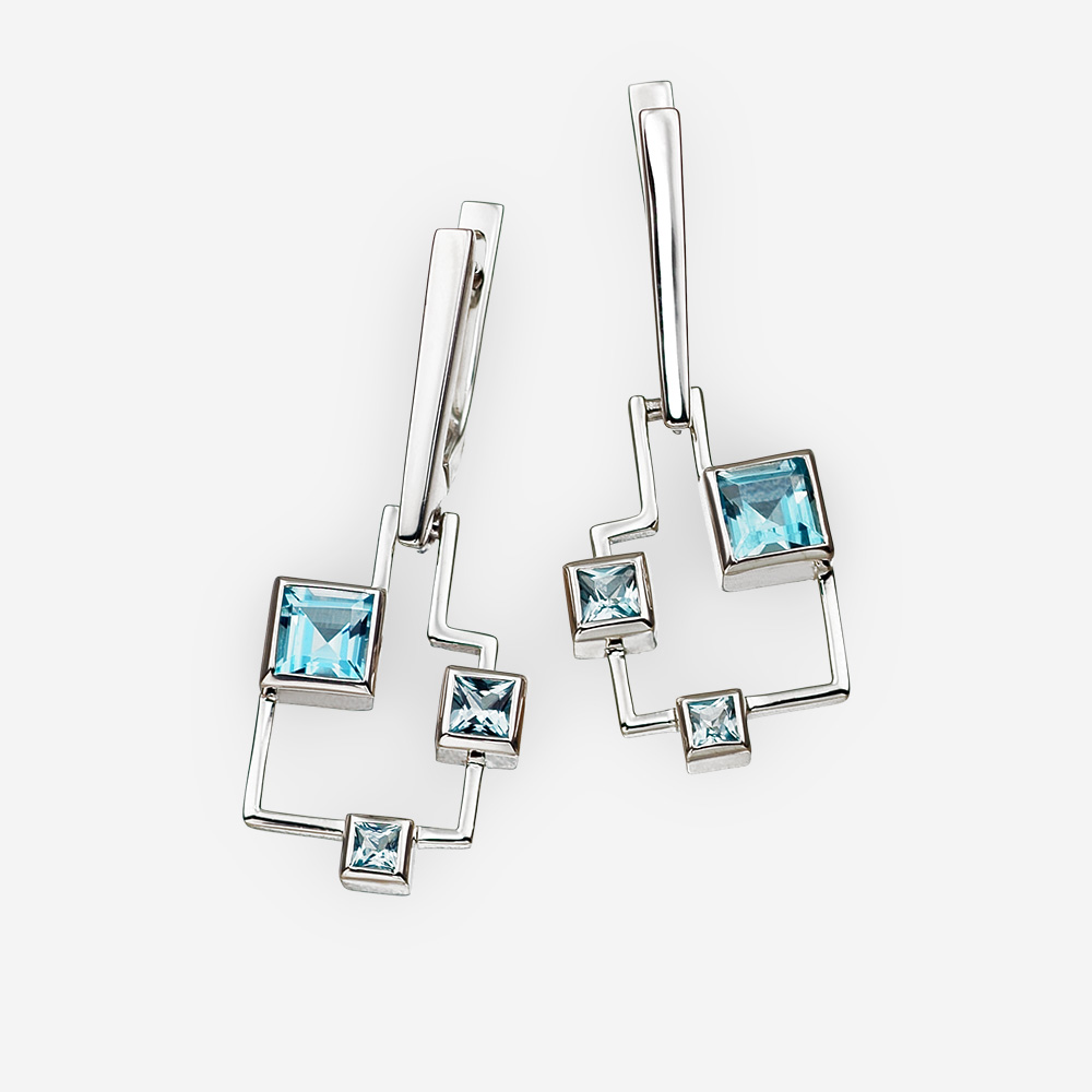 Aretes geométricos con topacio azul hechos de plata fina de .925.