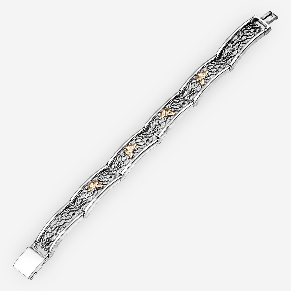 Pulsera de plata con enlaces de filigrana y con figuras de mariposas de oro de 14k.